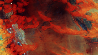 Libya's Dunes Look Like a Rusty Steel Plate From Space